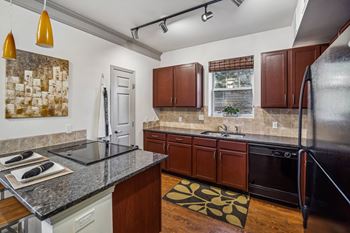 Cabinets with tiled back-splash in kitchen